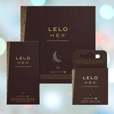 Three boxes of Lelo Hex 'Respect' XL Condoms by LELO are displayed. The packaging, featuring a dark design with gold text, is set against a backdrop of softly blurred lights. The selection includes a large box containing 36 condoms, a medium box with 12, and a small box of 3, each crafted with LELO's unique hexagonal structure for added strength.